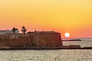 Sicily Gallery: Trapani, Sicily. Seascape of the Ligny tower with the sun setting in the sea