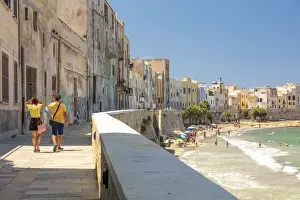 Mediterranean Area Prints: Trapani, Sicily. Seascape of the town with people walking on the baroque street
