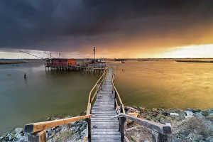 Cloudscape Prints: Trebuchet during a sunrise in Comacchio Lido, Emilia Romagna, Ferrara province in Italy