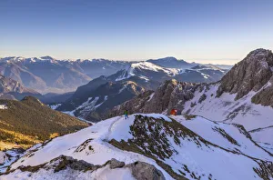 A trekker walks from CittÔêÜÔÇá di Clusone Bivouac, Castione della Pesolana, Prealpi Orobie, Bergamo, Lombardy, Italy (MR)