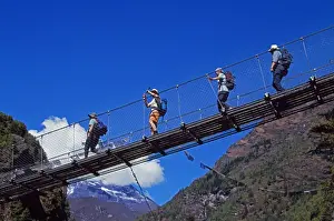 Foot Bridge Prints: Trekkers crossing a suspension bridge over the Dudh Kosi river