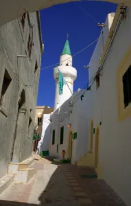 Libya Prints: Tripoli, Libya; A minaret and the Libyan flag visible on one of the Mosques in the Ancient Medina of