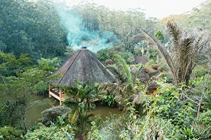 Madagascar Prints: Tropical resort, smoke rising, Madagascar, Africa. Andasibe, Analamazaotra. Vakona lodge