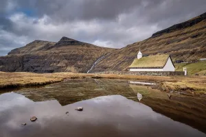 Denmark Prints: Turf roofed Saksun church reflected in a pond, Streymoy, Faroe Islands, Denmark, Europe