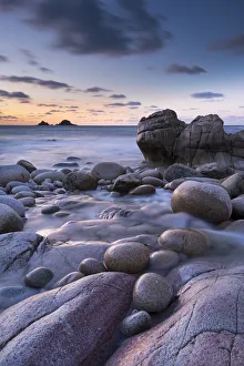 Porth Nanven Prints: Twilight on the rocky Cornish cove at Porth Nanven, Cornwall, England. Winter (December)