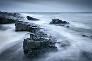 Twilight on the rocky shores of Spekes Mill Mouth, on the North Devon coast, England