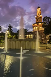 Twilight view of Sforza Castle or Castello Sforzesco and fountain, Milan, Lombardy, Italy