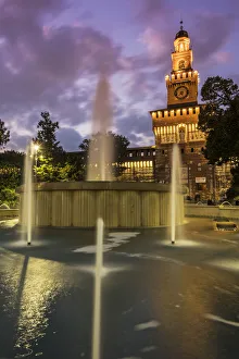 Twilight view of Sforza Castle or Castello Sforzesco and fountain, Milan, Lombardy, Italy Twilight view of Sforza Castle or Castello Sforzesco and fountain, Milan, Lombardy, Italy