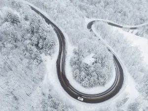 Lane Prints: Twisting road in winter with vehicle, Schuss Pass, Waitsfield, Vermont, USA