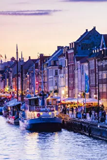 Images Dated 25th November 2019: Typical buildings along Nyhavn water canal in Copenhagen by night, Denmark