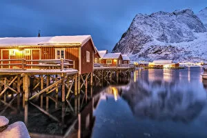 Frozen Gallery: The typical fishermen houses called Rorbu in Reine at dusk. Lofoten islands. Norway