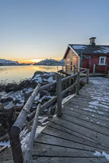 Nordland County Prints: Typical fishermen red house on the sea at dawn in winter. Svolvaer, Nordland county