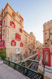 Telephone Box Prints: Typical Street Scene in the heart of Valletta, Red British Telphone Box, Valletta, Malta