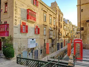 Street Scene Prints: Typical Street Scene in the heart of Valletta, Red British Telphone Box, Valletta, Malta