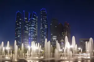 Abu Dhabi Emirate Prints: UAE, Abu Dhabi, Emirates Palace Hotel fountains and Etihad Towers, dusk