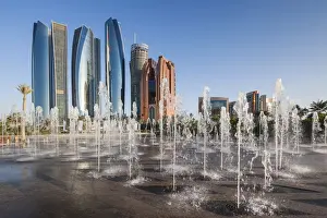 Abu Dhabi Emirate Prints: UAE, Abu Dhabi, Etihad Towers and Emirates Palace Hotel fountains, dusk