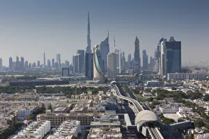UAE, Dubai, Downtown Dubai skyline above metro rail