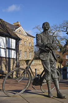 UK, England, Herefordshire, Hereford, Edward Elgar Statue leaning against his Sunbeam bicycle infront of Cathedral barn