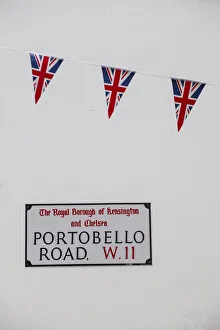 UK, England, London, Kensington, Union Jack bunting above Portobello Rd sign to celebrate