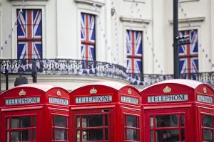 UK, England, London, The Strand, Red telephone box and Union Jack bunting to celebrate