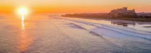 Northumbria Prints: UK, England, Northumberland, Bamburgh, Bamburgh Beach, Bamburgh Castle at sunrise