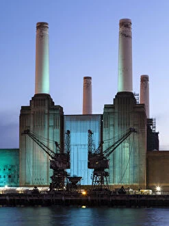 UK, London, Battersea power station illuminated by colored light at dusk