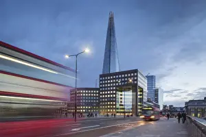 The Shard Prints: UK, London A view of The Shard from London Bridge at dusk with a tipycal London Double