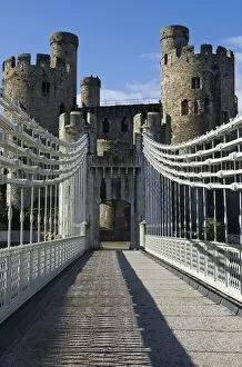 UK, North Wales; Conwy. The elegant Suspension Bridge built by Thomas Telford across the Conwy River to the imposing