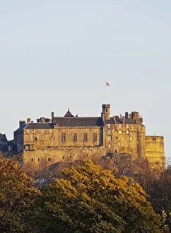 UK, Scotland, Lothian, Edinburgh, View of the Edinburgh Castle illuminated by the sunrise