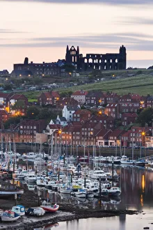 United Kingdom, England, North Yorkshire, Whitby. The Abbey and harbour before sunrise