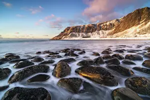 Unstad Beach with Kleivheia mountain in the background in winter at sunset