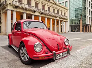 Uruguay, Montevideo, Red Volkswagen Beetle parked in front of the Estevez Palace
