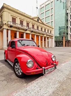 Uruguay, Montevideo, Red Volkswagen Beetle parked in front of the Estevez Palace