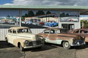 USA, Colorado, Delta County, Delta, Rusty cars parked outside shop