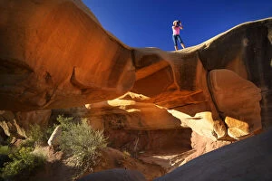 USA, Colorado Plateau, Utah, Woman photographing The Devils Garden of the Grand