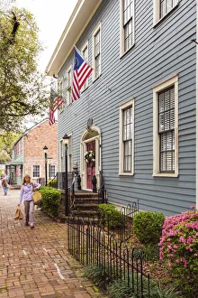 Images Dated 16th May 2016: USA, Georgia, Savannah Woman walking past a typical house