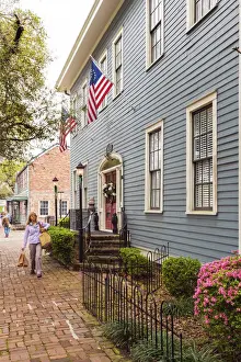 Poeple Prints: USA, Georgia, Savannah Woman walking past a typical house