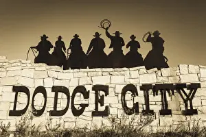 Central Prints: USA, Kansas, Dodge City, city sign with cowboy silhouettes
