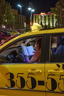 Images Dated 2nd February 2016: USA, Nevada, Reno, woman cabbie reading in cab at night