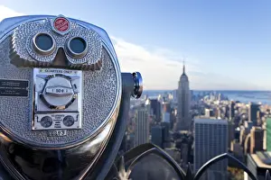 USA, New York City, Manhattan, Coin operated Binoculars and the Empire State Building viewed from the top of