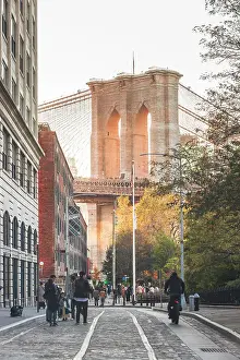 Brooklyn Bridge Prints: USA, New York City, People walking in Dumbo district (Brooklyn) with the Brooklyn bridge in the background