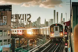 Q4 2023 Prints: USA, New York City, the train 7 approaching an elevated station in Queens with Manhattan in the background