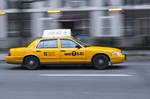USA, New York, New York City, yellow city cab speeding along a New York street