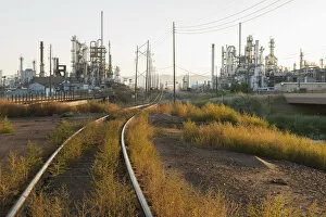 USA, Southwest, Colorado, El Paso County, Denver, Train tracks near a refinery