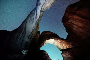 February Gallery: USA, Utah, Double Arches rock formations illuminated by night in the Arches National Park