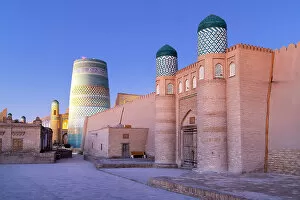 What's New: Uzbekistan, Khiva, the Khuna Ark citadel and the Kalta Minor minaret illuminated at sunrise