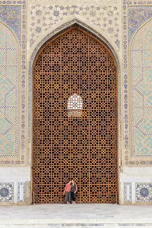 What's New: Uzbekistan, Samarkand, Bibi-khanym mosque, two women stand in the huge doorway