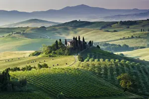 Val d Orcia, Tuscany, Italy. A lonely farmhouse with cypress and olive trees