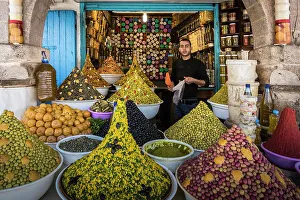 Stall Prints: Vendor in olive and spice shop in market in the medina (old city), Essaouira, Morocco