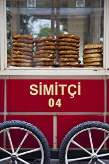 Vendor selling bread rools on red Trolley with Beyoglu area, Istanbul, Turkey